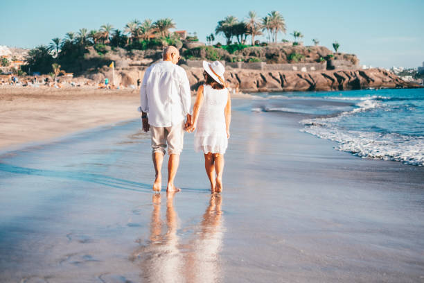 A couple walking together along the beach
